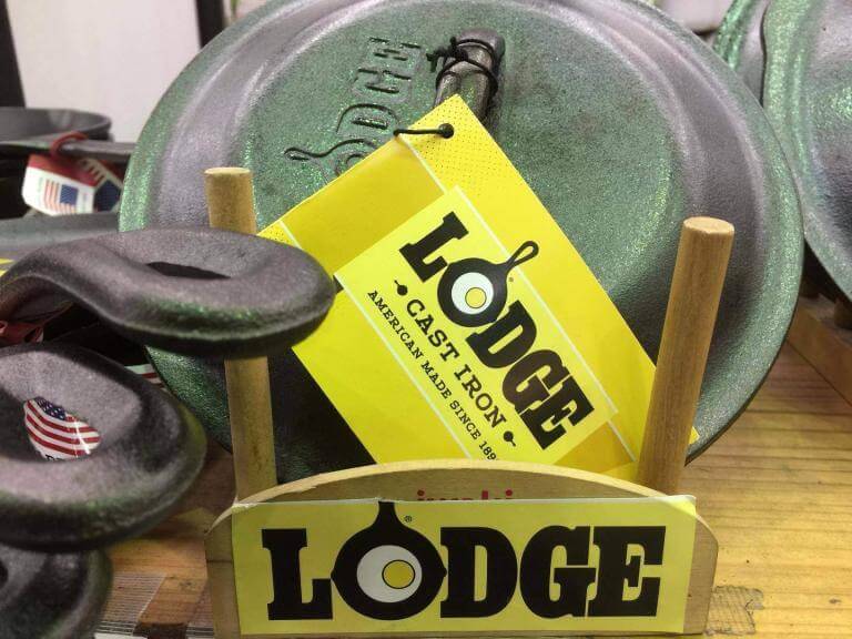 Skillet cover rack with skillet lids. Lodge label in front and yellow label on skillet cover.