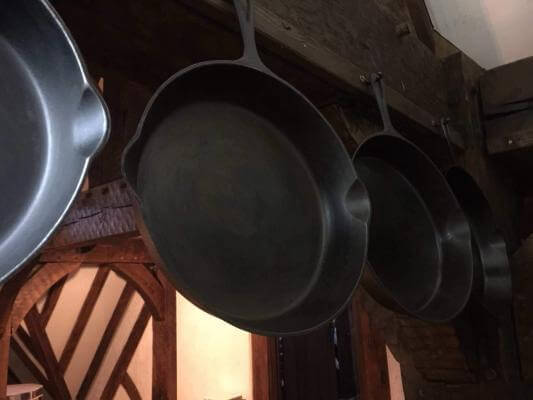 Theres are so many benefits cooking with cast iron. In this photo three skillets are proudly displayed.