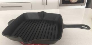 Black Staub grill pan on cherry red Staub trivet.