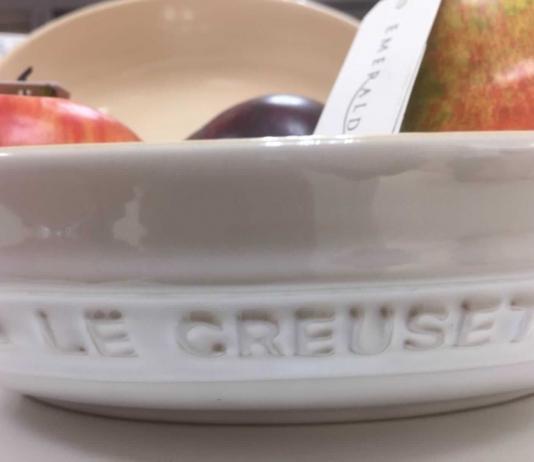 Is Le Creuset Ceramic Cookware Better? Is Le Creuset ceramic cookware good. (in the picture is a white ceramic bowl filled with fruit).