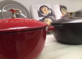 Two Staub Dutch ovens. One Red the other is black. The knobs are made of brass and both are some of the best Dutch ovens you can buy