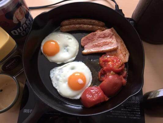 English breakfast cooking in a vintage cast-iron skillet