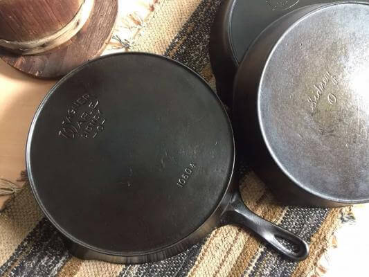 Wagner cast iron with two other antique cast iron skillets.