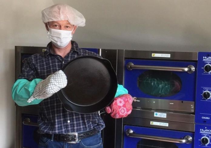 Is cast iron cookware safe to cook with? Boonie Hicks writer holding a cast iron pan.